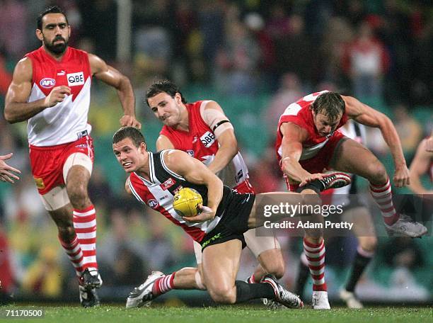 Luke Ball of the Saints is tackled by Tadhg Kennelly of the Swans during the round 11 AFL match between the Sydney Swans and the St Kilda Saints at...