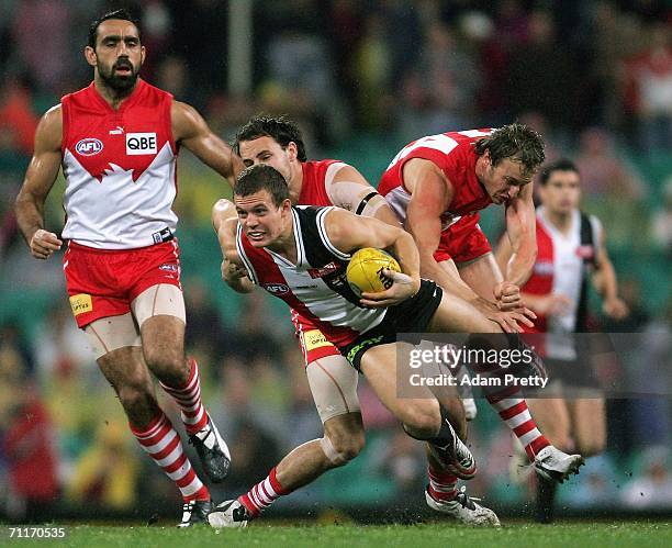 Matthew Maguire of the Saints is tackled by Tadhg Kennelly of the Swans during the round 11 AFL match between the Sydney Swans and the St Kilda...