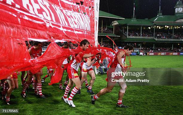 Jude Bolton of the Swans runs through the banner before the round 11 AFL match between the Sydney Swans and the St Kilda Saints at the Sydney Cricket...