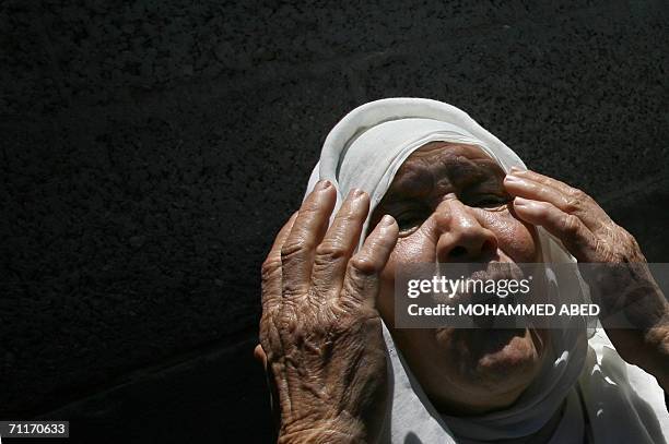 An elderly Palestinian woman mourns during the funeral of the Ghali family, killed yesterday in Israeli shelling of the northern Gaza seafront, in...