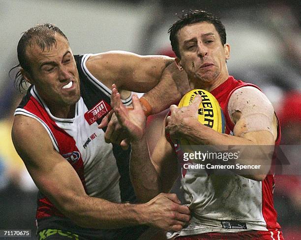 Leo Barry of the Swans is tackled by Fraser Gehrig of the Saints during the round 11 AFL match between the Sydney Swans and the St Kilda Saints at...