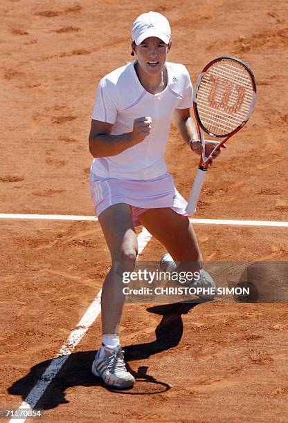 Belgian Justine Henin-Hardenne celebrates after winning a point to Russian Svetlana Kuznetsova during the French tennis Open finals at Roland Garros...
