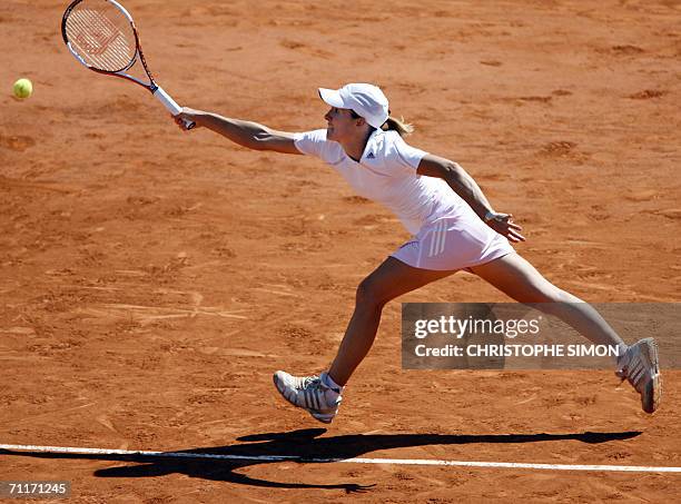 Belgian Justine Henin-Hardenne tries to return the ball to Russian Svetlana Kuznetsova during the French tennis Open final at Roland Garros in Paris...