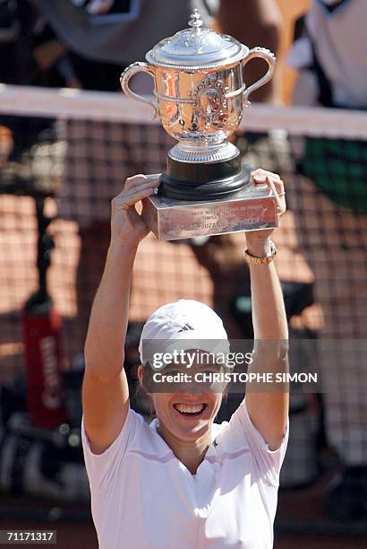 Belgian Justine Henin-Hardenne holds the trophy after winning against Russian Svetlana Kuznetsova during the French tennis Open final at Roland...