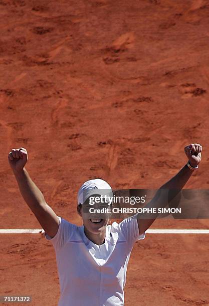 Belgian Justine Henin-Hardenne celebrates after defeating Russian Svetlana Kuznetsova during the French tennis Open finals at Roland Garros in Paris...