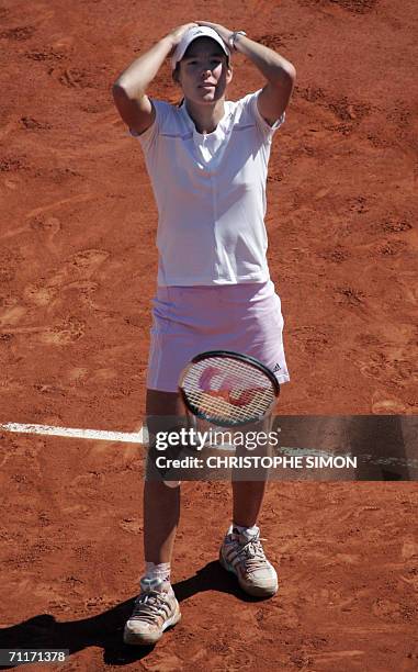 Belgian Justine Henin-Hardenne celebrates after defeating Russian Svetlana Kuznetsova during the French tennis Open finals at Roland Garros in Paris...