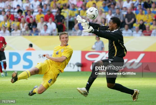 Anders Svensson of Sweden has a shot on goal as goalkeeper, Shaka Hislop of Trinidad & Tobago, tries to block during the FIFA World Cup Germany 2006...