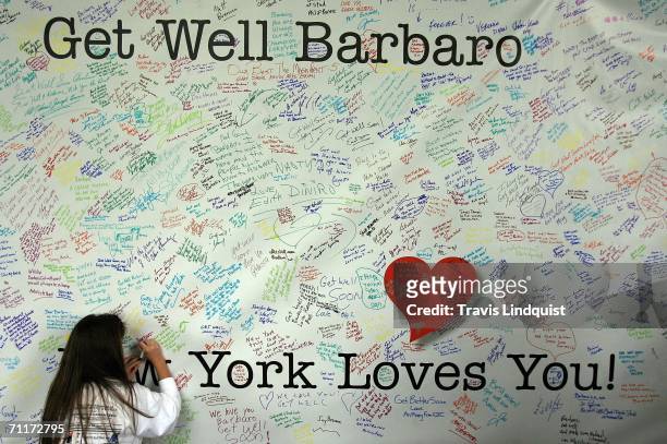 Nicole Friend of New Jersey signs a get well card for Barbaro before 138th running of of the Belmont Stakes on June 10, 2006 at Belmont Park in...