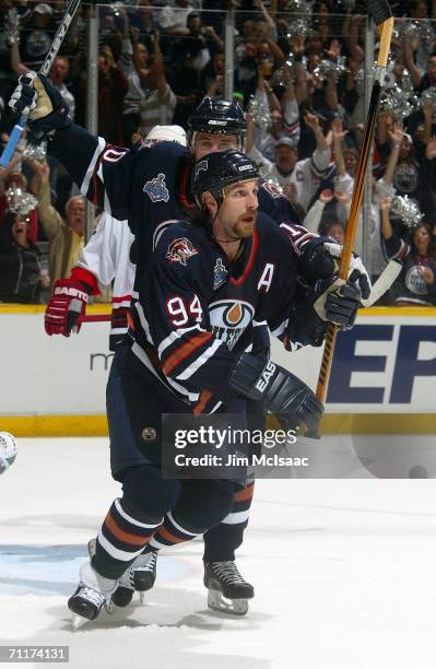 Ryan Smyth of the Edmonton Oilers and teammate Shawn Horcoff celebrate after Smyth scored the game winning goal over the Carolina Hurricanes during...