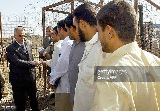 Iraqi Vice President Tariq al-Hashemi shakes hands with some Iraqi prisoners before their release 11 June, 2006 at Abu Ghraib prison west of Baghdad....