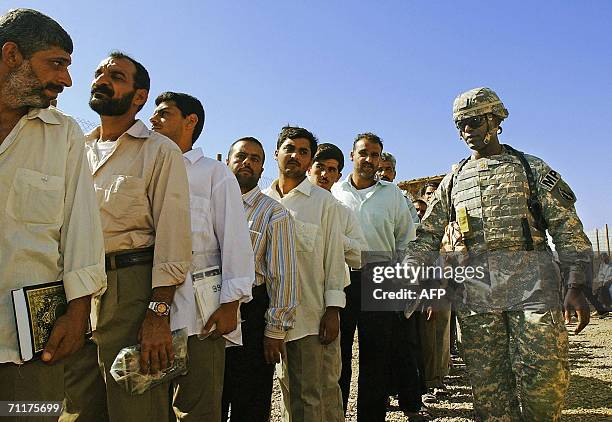 Iraqi prisoners wait to be released 11 June 2006 at Abu Ghraib prison west of Baghdad. Iraq released 230 detainees today, the second batch of...