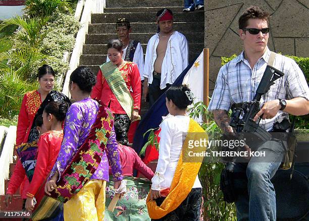 Soldier in civilian clothing secures the Tawi-Tawi capitol during the opening ceremony of the USNS Mercy's arrival in Bongao, Tawi-Tawi 11 June 2006....