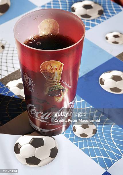 World Cup branded Coca-Cola drink sits on a football patterned table cloth on June 11, 2006 in Frankfurt, Germany. On the third day of the FIFA World...