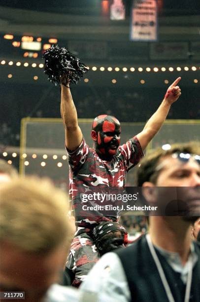 Fan of the Orlando Predators celebrates as he is dresses in team colors and painted face after the Arena Bowl Game against the Nashville Kats at the...