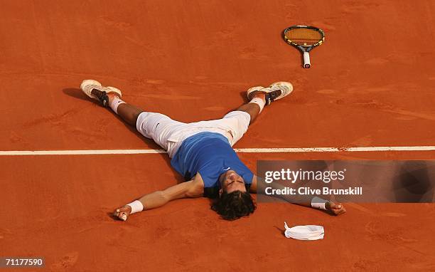 Rafael Nadal of Spain lies on the clay after defeating Roger Federer of Switzerland during the Men's Singles Final on day fifteen of the French Open...