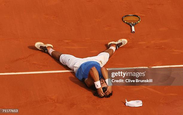 Rafael Nadal of Spain lies on the clay after defeating Roger Federer of Switzerland during the Men's Singles Final on day fifteen of the French Open...