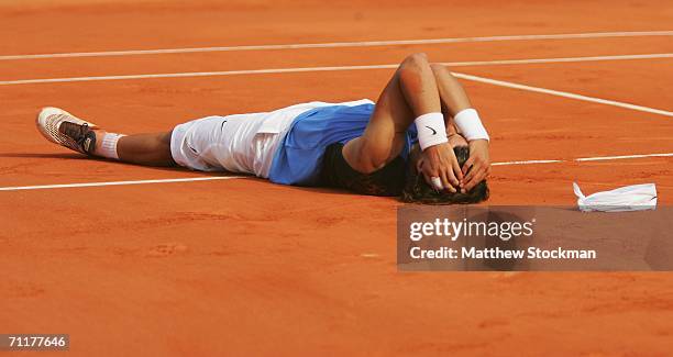 Rafael Nadal of Spain lies on the clay after defeating Roger Federer of Switzerland during the Men's Singles Final on day fifteen of the French Open...