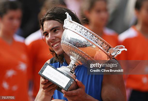 Rafael Nadal of Spain holds the trophy after defeating Roger Federer of Switzerland during the Men's Singles Final on day fifteen of the French Open...