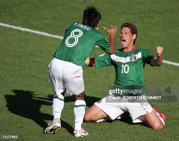 Mexican midfielder Pavel Pardo celebrates with Mexican forward Guillermo Franco after teammate Omar Bravo scores the team's first goal against Iran...