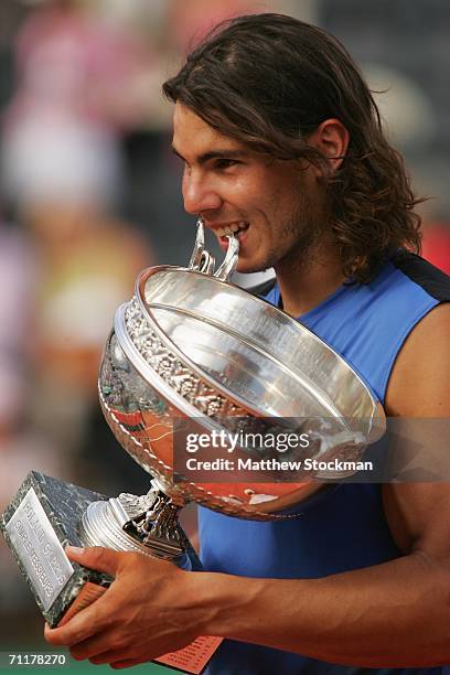 Rafael Nadal of Spain holds the trophy after defeating Roger Federer of Switzerland during the Men's Singles Final on day fifteen of the French Open...