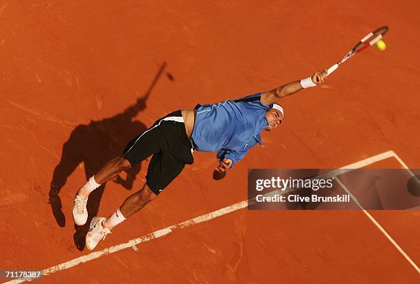 Roger Federer of Switzerland serves against Rafael Nadal of Spain during the Men?s Singles Final on day fifteen of the French Open at Roland Garros...