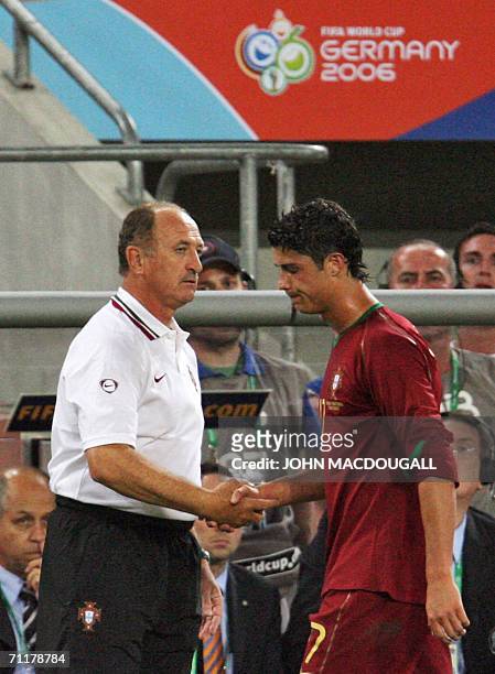 Portuguese forward Cristiano Ronaldo shakes hands with Brazilian head coach of the Portuguese team Luiz Felipe Scolari as he leaves the pitch during...