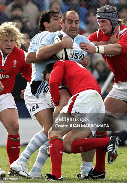 Puerto Madryn, ARGENTINA: Argentina's Mario Ledesma and teammate Jose Maria Nunez Piossek protect the ball from Wales' Duncan Jones , Lee Byrne and...
