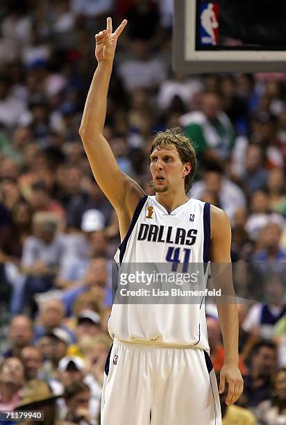 Dirk Nowitzki of the Dallas Mavericks raises two fingers in the air in the first half against the Miami Heat in game two of the 2006 NBA Finals on...