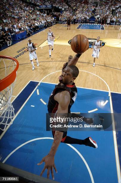 Dwyane Wade of the Miami Heat drives to the basket for a dunk against the Dallas Mavericks during Game Two of the 2006 NBA Finals June 11, 2006 at...