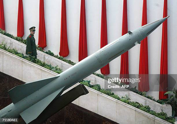 In this file picture taken 06 December 2004, a soldier walks down a stairway behind a Chinese-made Hongqi-2 missile on display at the Military Museum...