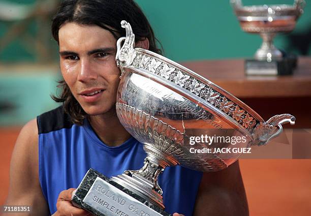 Spain's Rafael Nadal cries while holding the trophy after defeating Swiss Roger Federer during the French tennis Open finals at Roland Garros in...