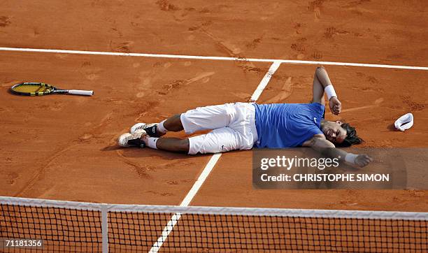 Spain's Rafael Nadal celebrates after defeating Swiss Roger Federer during the French tennis Open finals at Roland Garros in Paris 11 June 2006. AFP...