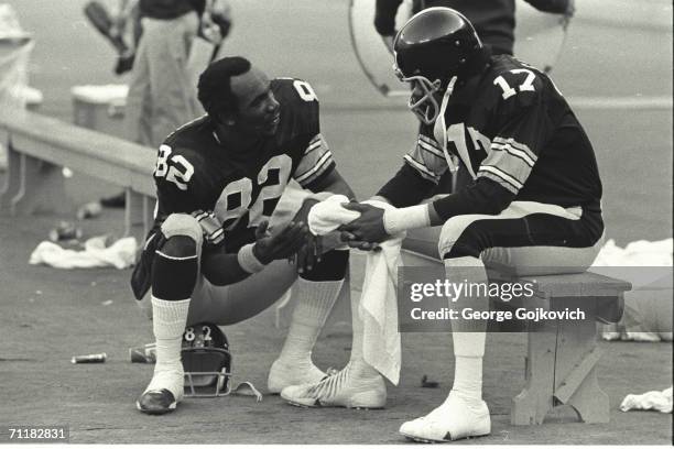 Wide receiver John Stallworth of the Pittsburgh Steelers talks with quarterback Joe Gilliam during a game at Three Rivers Stadium circa 1975 in...