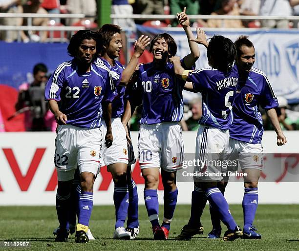 Shunsuke Nakamura of Japan celebrates with teammates after scoring the opening goal during the FIFA World Cup Germany 2006 Group F match between...