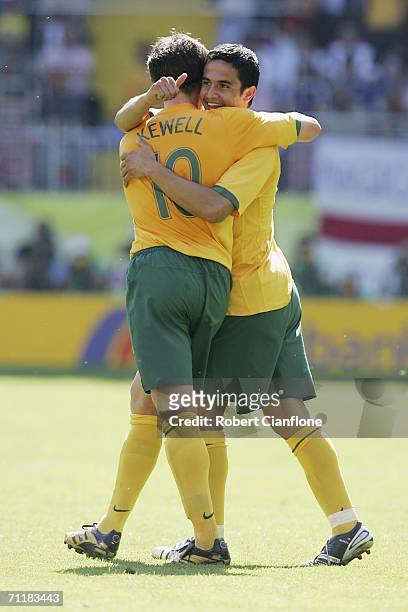 Tim Cahill of Australia celebrates with teammate Harry Kewell, after scoring his team's first goal during the FIFA World Cup Germany 2006 Group F...