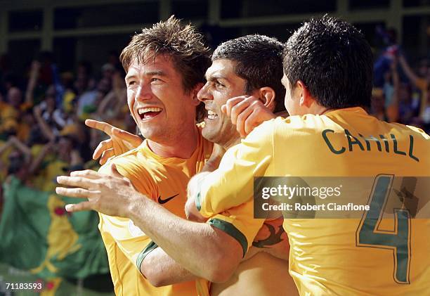 Scorer of Australia's third goal, John Aloisi , is congratulated by teammates Harry Kewell and Tim Cahill during the FIFA World Cup Germany 2006...