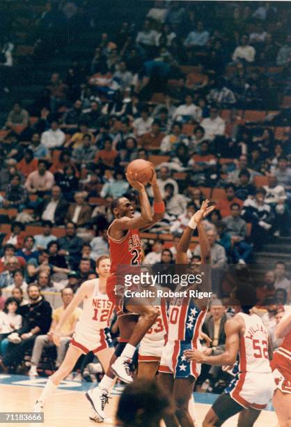 American basketball player Michael Jordan of the Chicago Bulls jumps for a shot during a game against the New Jersey Nets at the Meadowlands Arena ,...