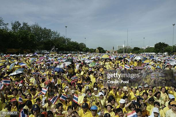 Thousands of people waiting outside the Royal Plaza wave to pay tribute to King Bhumibol Adulyadej on June 9, 2006 in Bangkok, Thailand. Thailand...