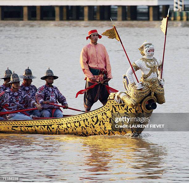 Signalman stands behind a Krut, or garuda, steed of Vishnu, while navigating the Chao Phraya river during the Royal barge procession in honor of...