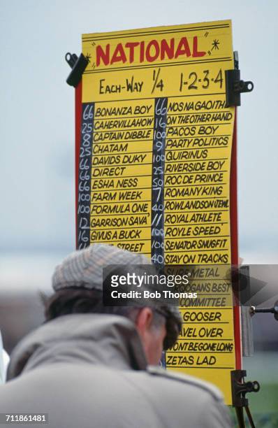 Spectator studies the odds at a bookmaker's stand at the Grand National at Aintree Racecourse, Liverpool, 3rd April 1993. The race was declared void...
