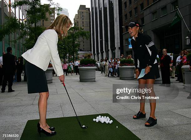 Golfer Natalie Gulbis of the LPGA Tour watches Juliet Huddy of Fox's Dayside show hit golf balls to promote the HSBC Women?s World Match Play...