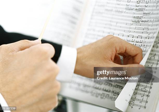 man turning pages of sheet music - hand turning page stock pictures, royalty-free photos & images