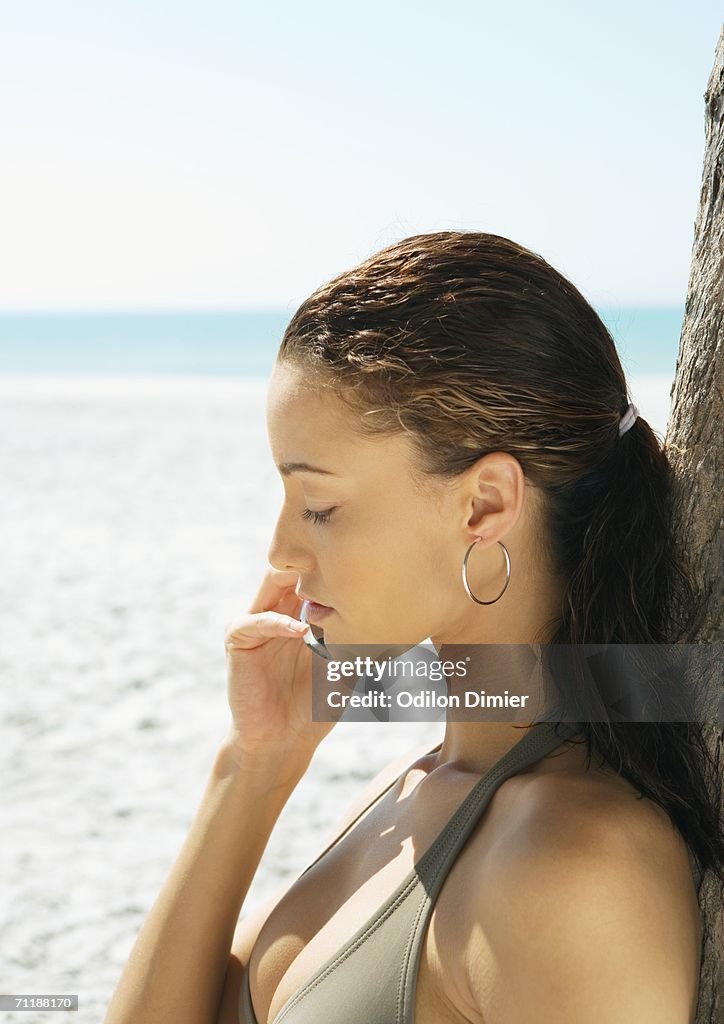 Woman using cell phone on beach