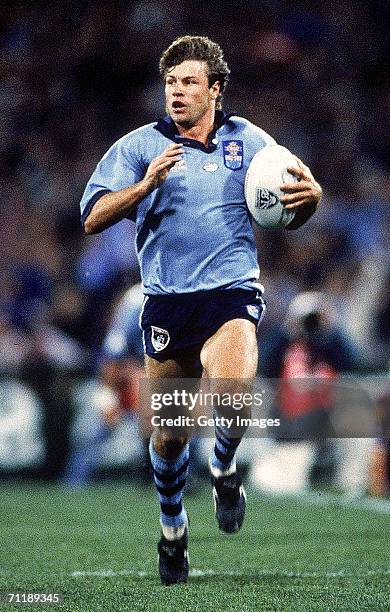 Andrew Ettingshausen of the Blues makes a break during game three of the ARL State of Origin match between the Queensland Maroons and the New South...