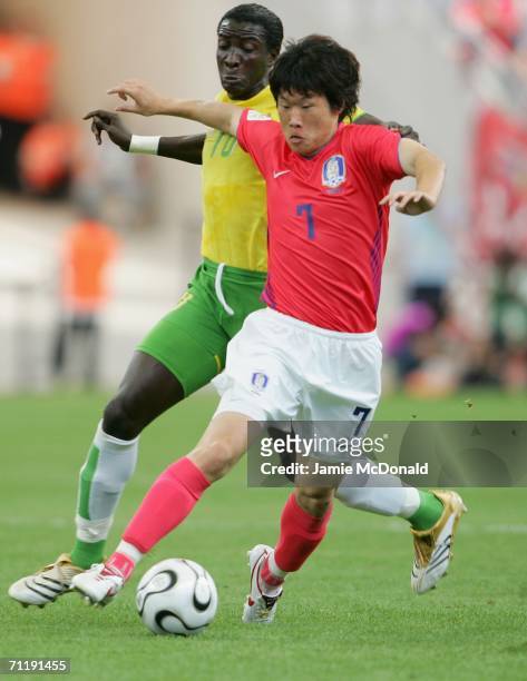 Ji-Sung Park of South Korea and Mamam Cherif-Toure of Togo battle for the ball during the FIFA World Cup Germany 2006 Group G match between South...