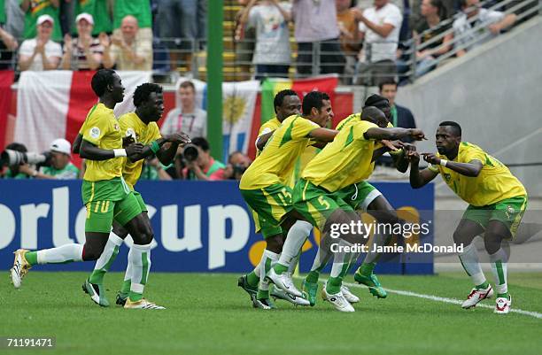 Kader Mohamed of Togo is congratulated by team mates after scoring the opening goal during the FIFA World Cup Germany 2006 Group G match between...