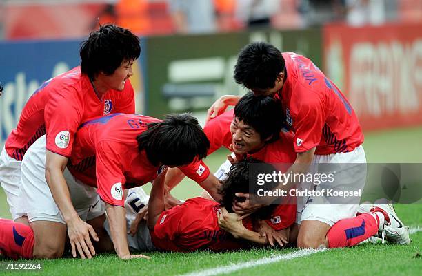 Jung-Hwan Ahn of South Korea is swamped by team mates after he scored the second goal for his team during the FIFA World Cup Germany 2006 Group G...