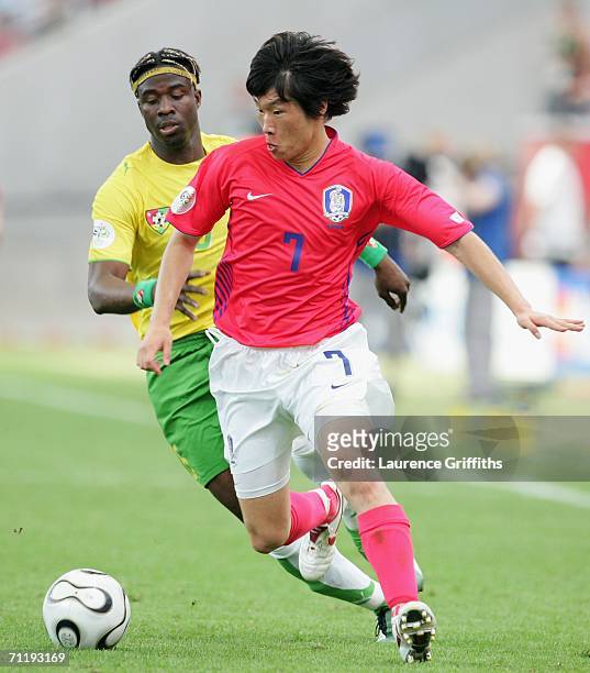 Ji-Sung Park of South Korea gets away from Yao Aziawonou of Togo during the FIFA World Cup Germany 2006 Group G match between South Korea and Togo at...