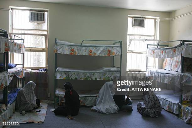 Iranian women inmates sit at their cell in the infamous Evin jail, north of Tehran, 13 June 2006. AFP PHOTO/ATTA KENARE
