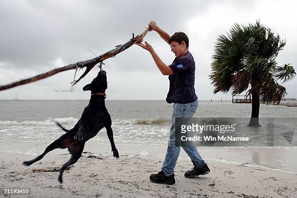Cliff Blackwell plays with his dog Gal in the increased surf brought in by Tropical Storm Alberto June 13, 2006 in Cedar Key, Florida. Alberto. The...